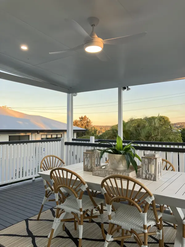 Outdoor ceiling fan and lighting on a deck at sunset