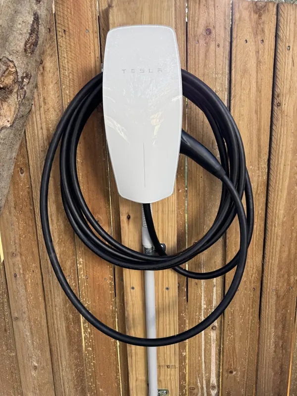 Wall-mounted EV charger installed on a timber wall