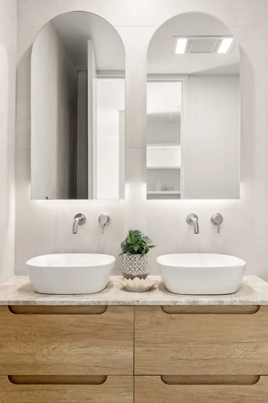 Ensuite double vanity with backlit mirrors and LED strip lighting under each vanity