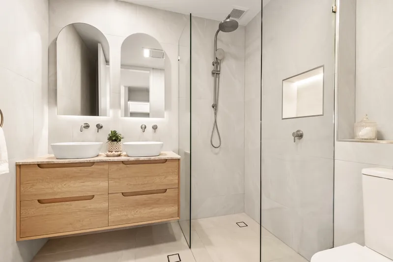 Ensuite with backlit mirrors, LED strip under the vanity and a lit shower niche