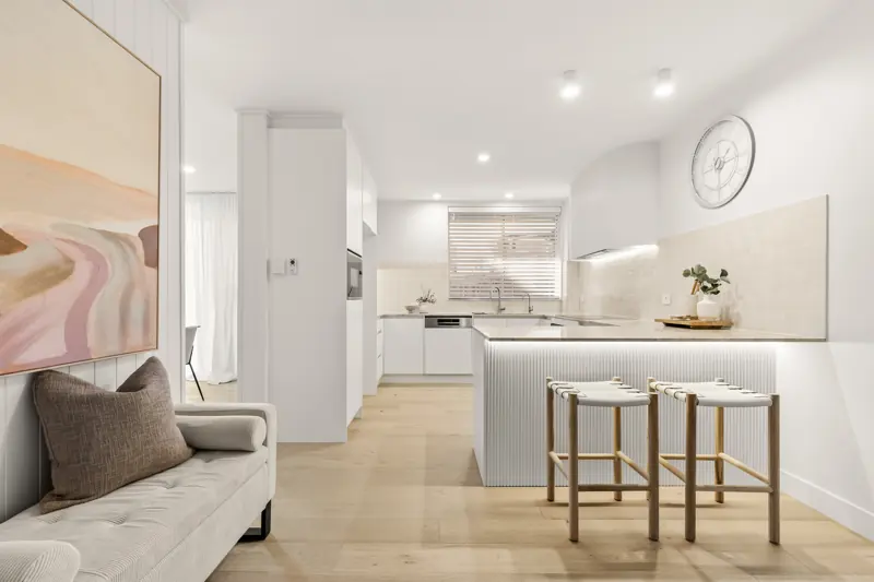 Renovated Toowong apartment kitchen with LED strip under the island bench and LED downlights
