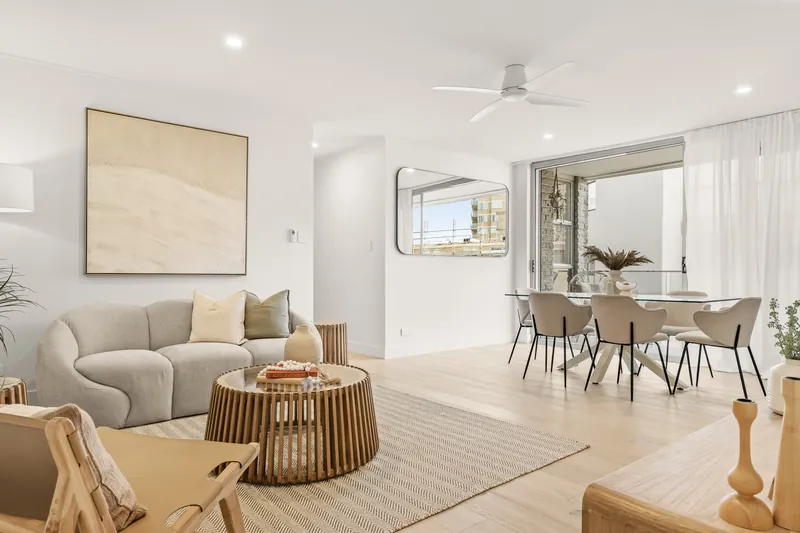 Open-plan living room with low-profile ceiling fan and LED downlights