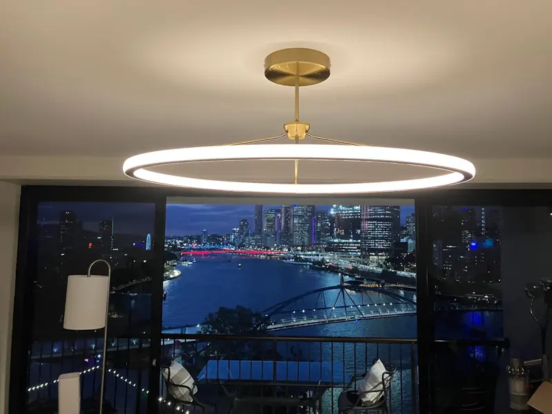 LED ring pendant light overlooking Brisbane city and the Story Bridge at night