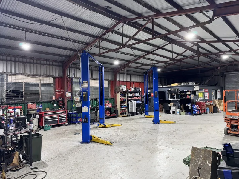 Mechanical workshop with vehicle hoists and LED high bay lighting